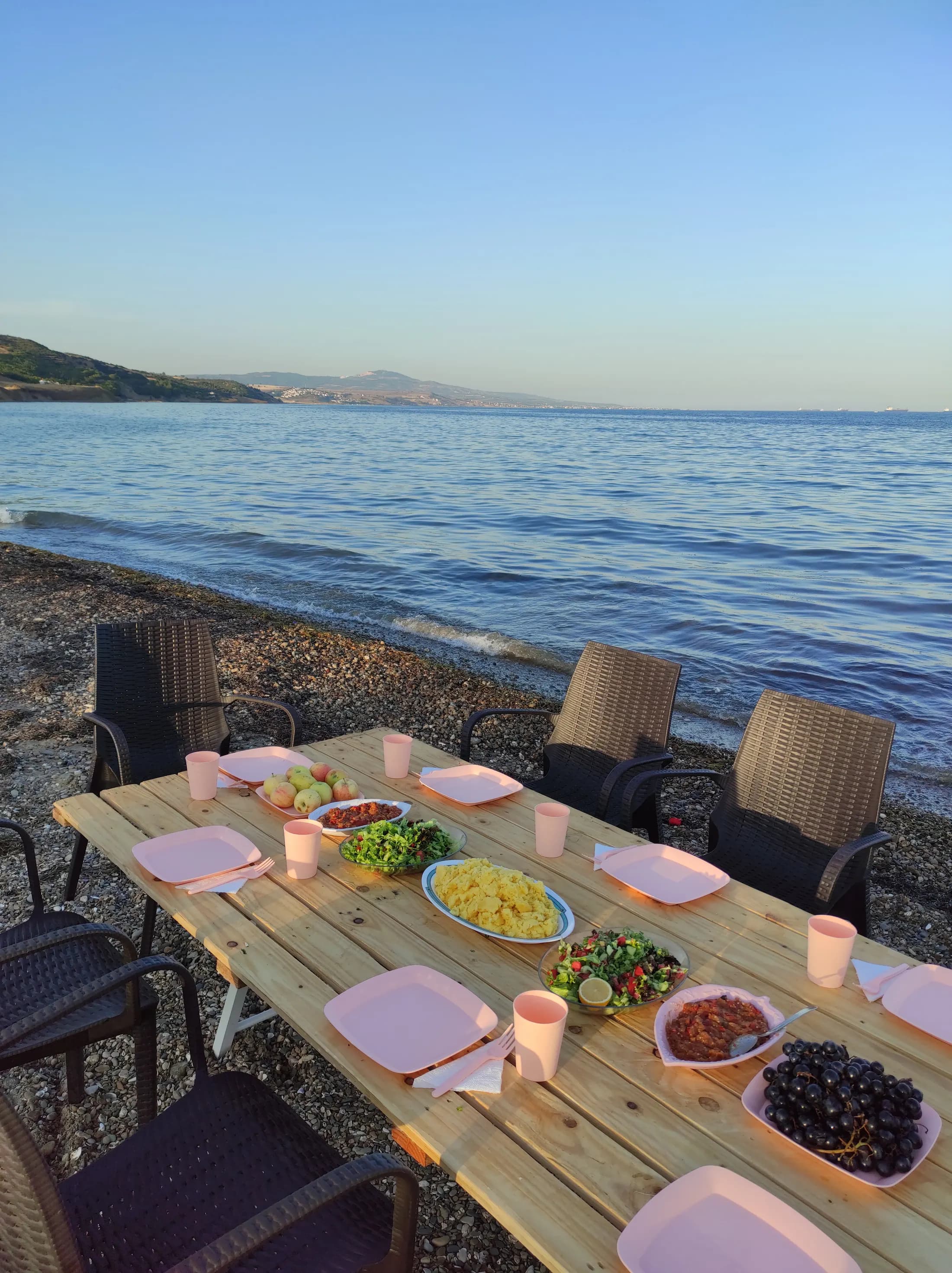 Gün batımında su kıyısında hazırlanmış bir masa
